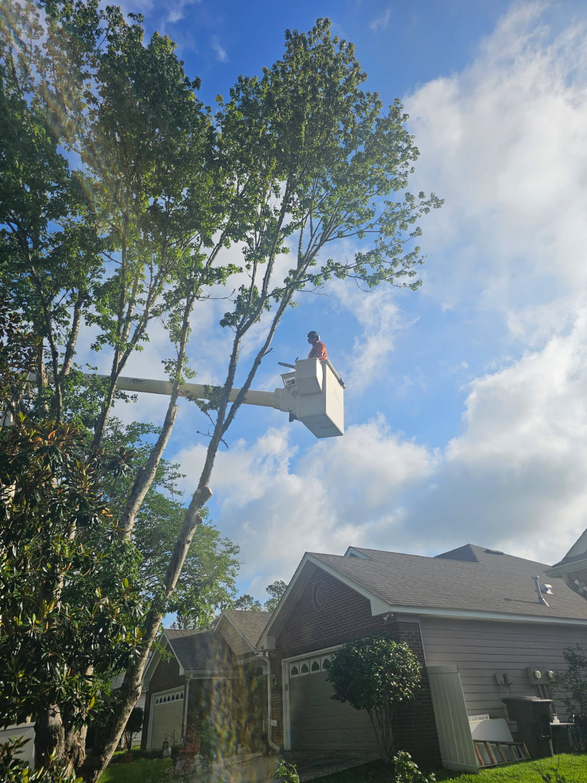 H&L team member working from a bucket near a home